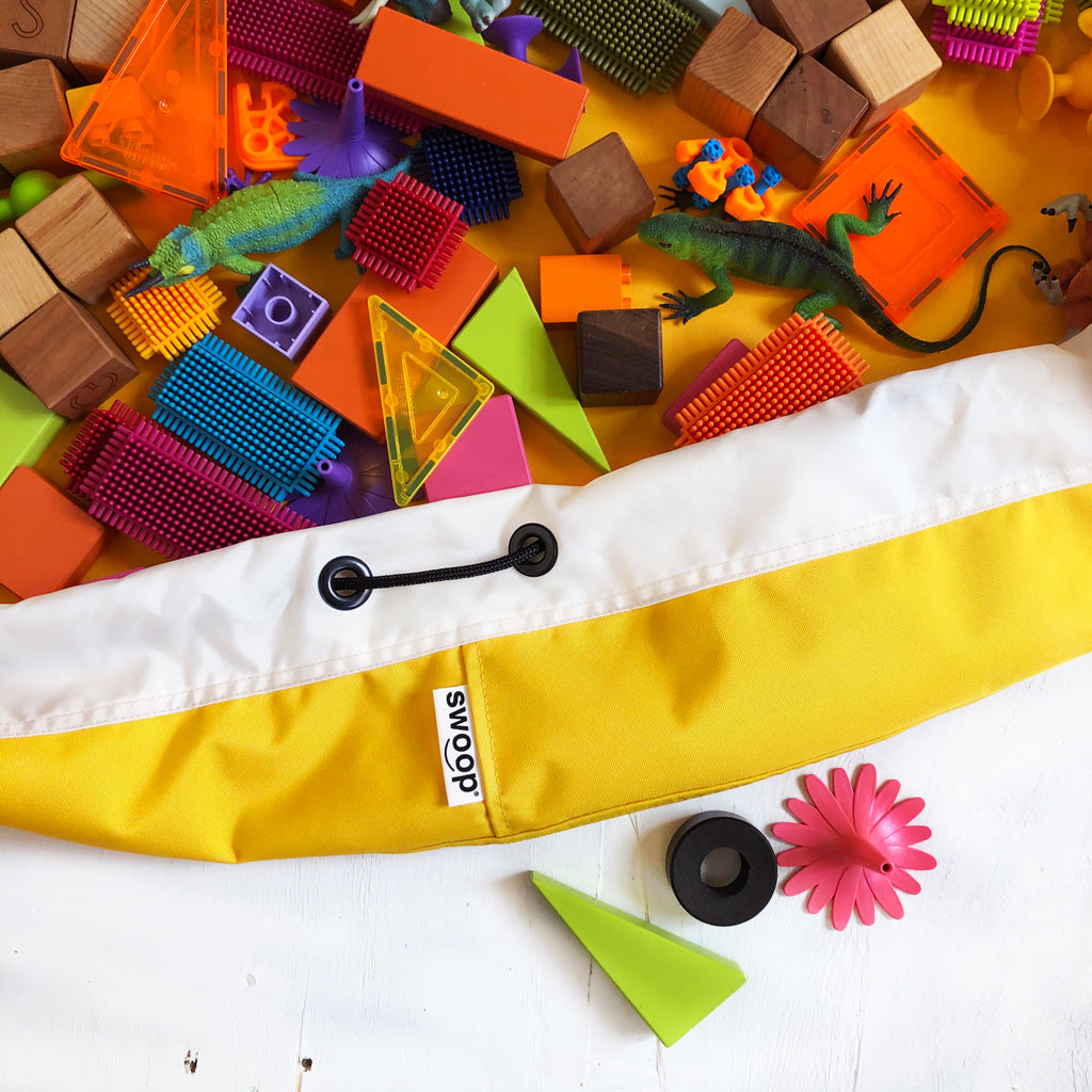 detail of yellow swoop bag with toys